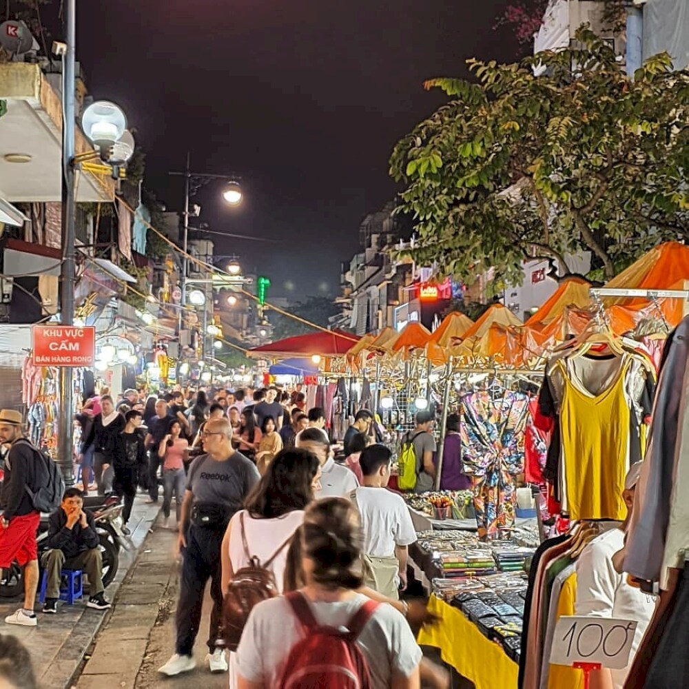 Visitors strolling through Hanoi’s vibrant streets at night